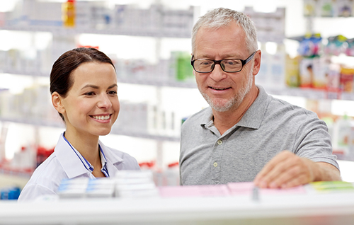 Pharmacist consulting a patient on his medication