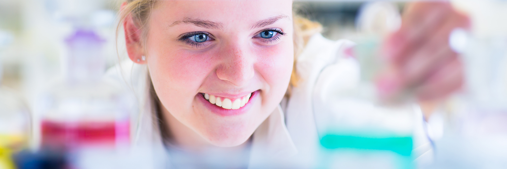 Close up of Young female pharmacist looking at medicine on shelf 
