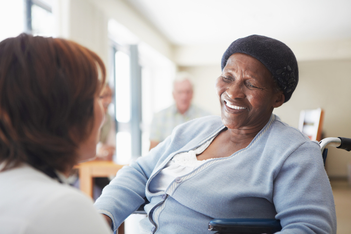 Elderly woman in a wheelchair smiling